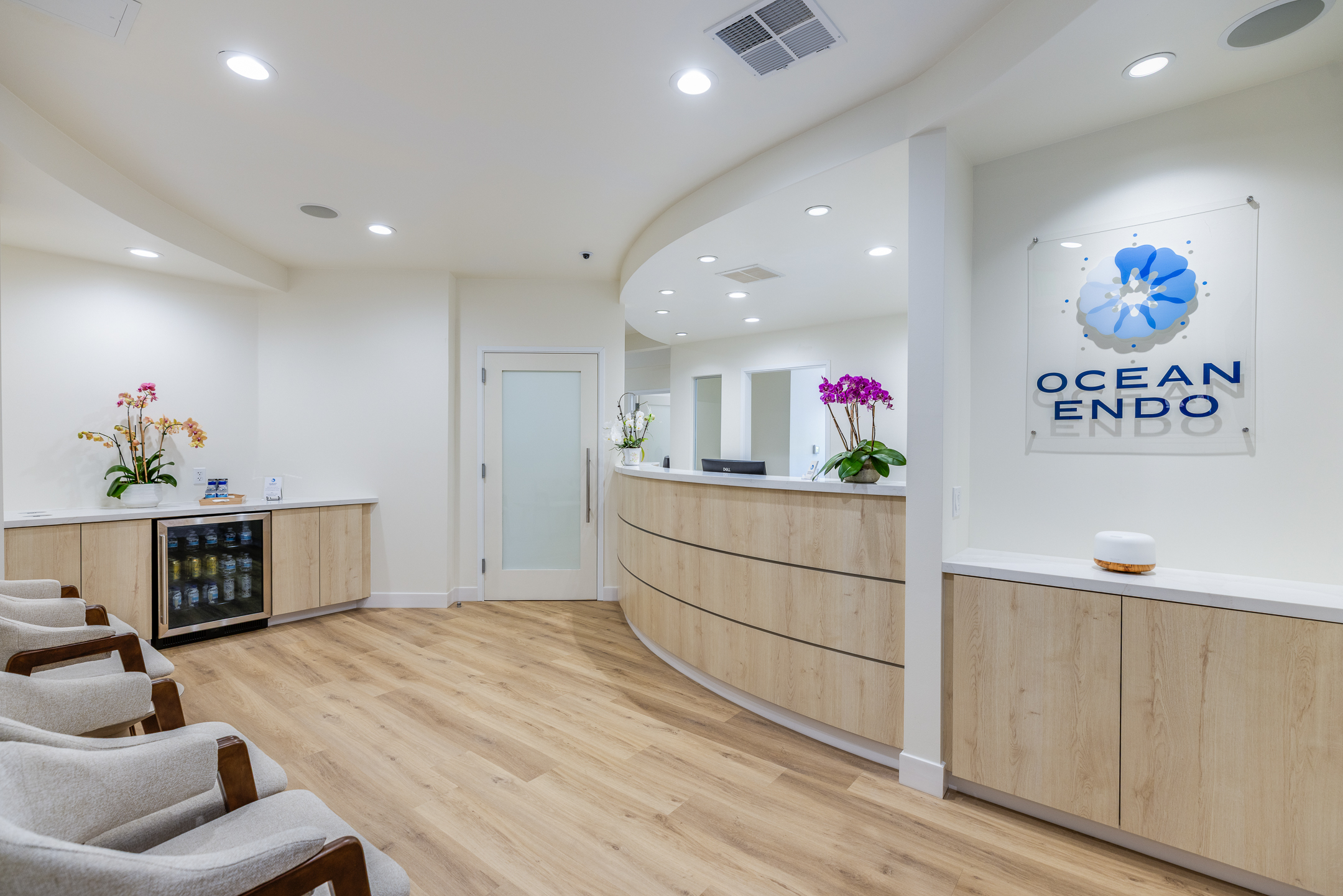 Reception area with waiting chairs and Ocean Endo logo wall at Ocean Endodontics in San Francisco