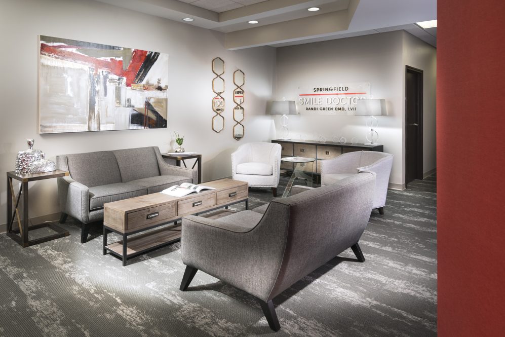 Reception and waiting area with sofas and signage at Springfield Smile Doctor in Springfield, MO