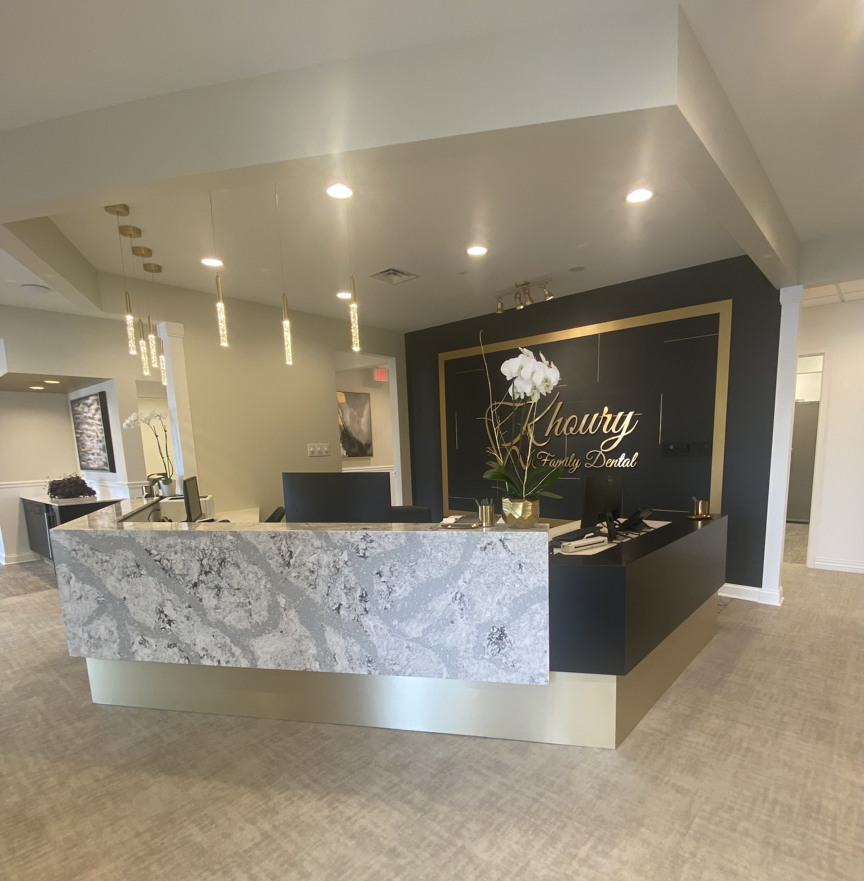 Reception desk with Khoury Family Dental signage in Vernon Hills office