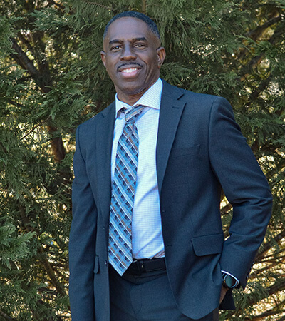 Dentist in suit and tie standing outdoors at Martindale Family Dentistry in Griffin, GA