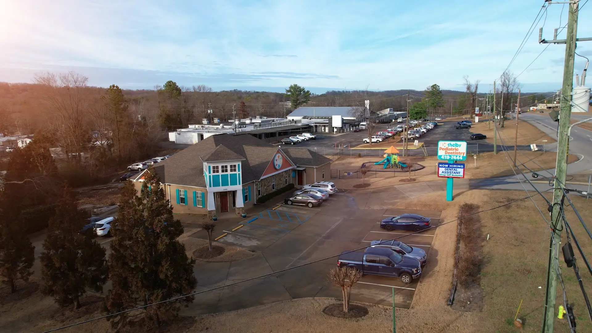 Aerial view of Shelby Pediatric Dentistry building, parking lot, sign, and playground in Pelham, AL