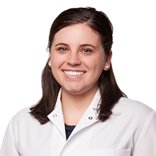 Portrait of a smiling dental team member in a white coat at Sparks Modern Dentistry in Sparks, NV