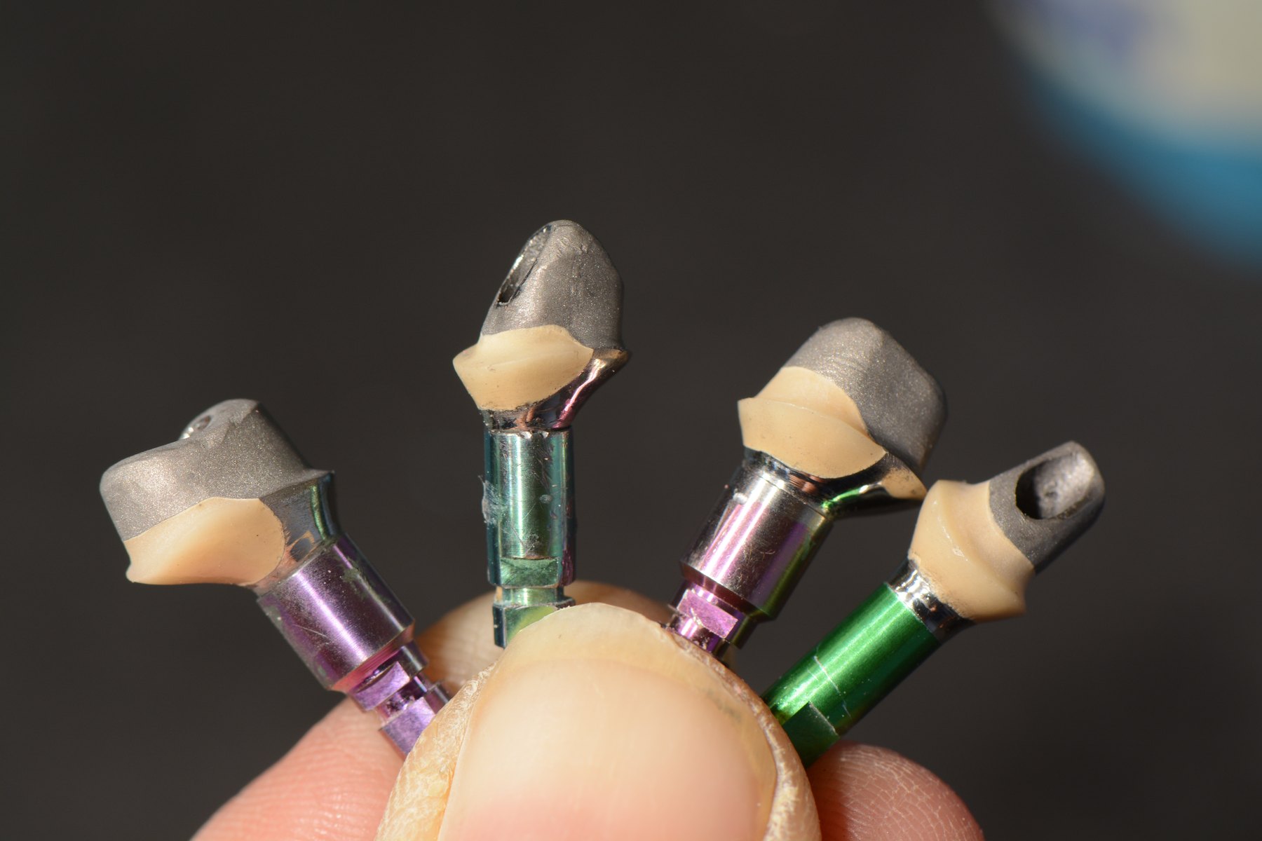 Close-up of dental implant abutments held in hand at Smile to Me