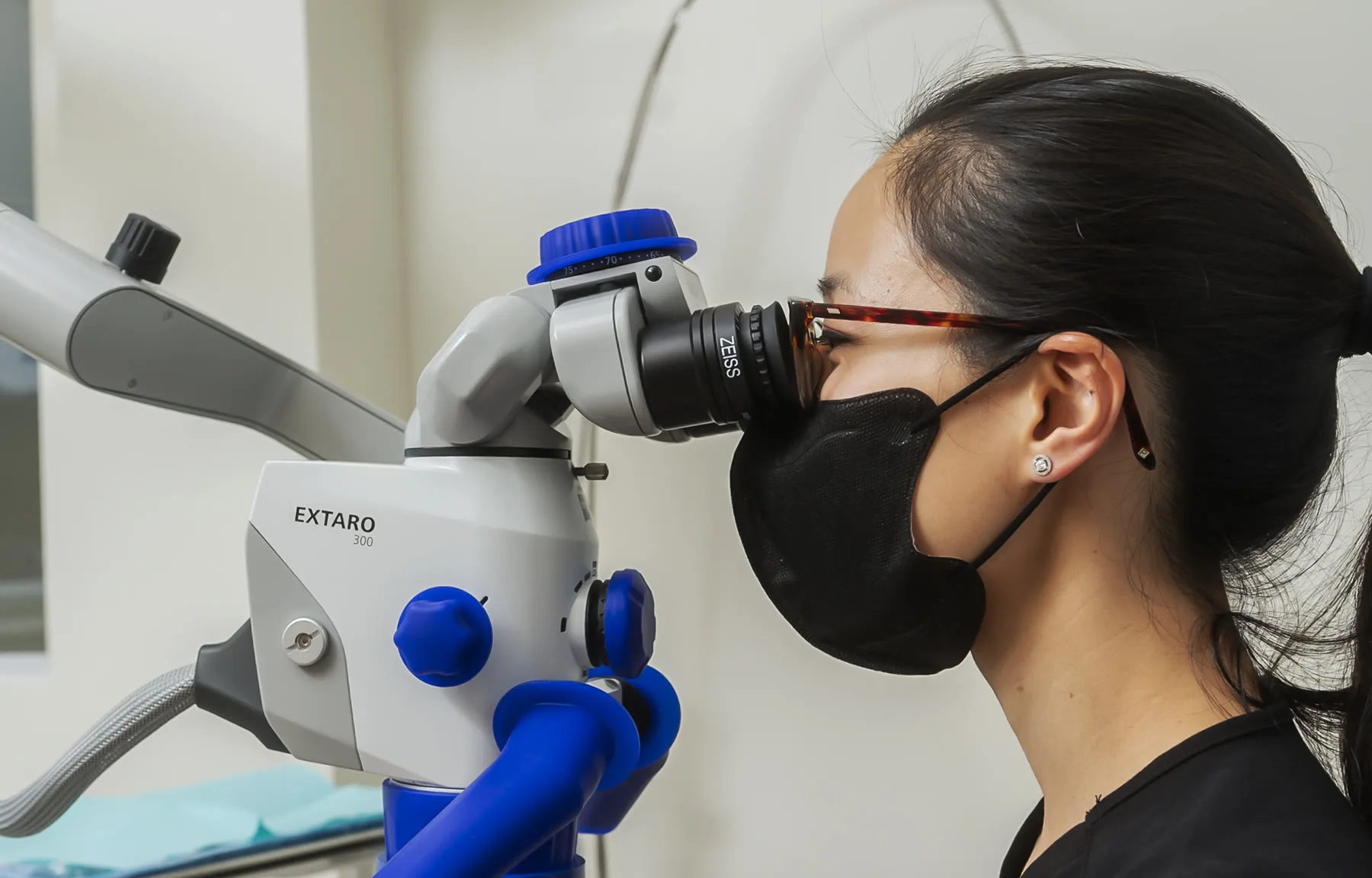 Dentist using a dental operating microscope during a procedure at Ocean Endodontics in San Francisco