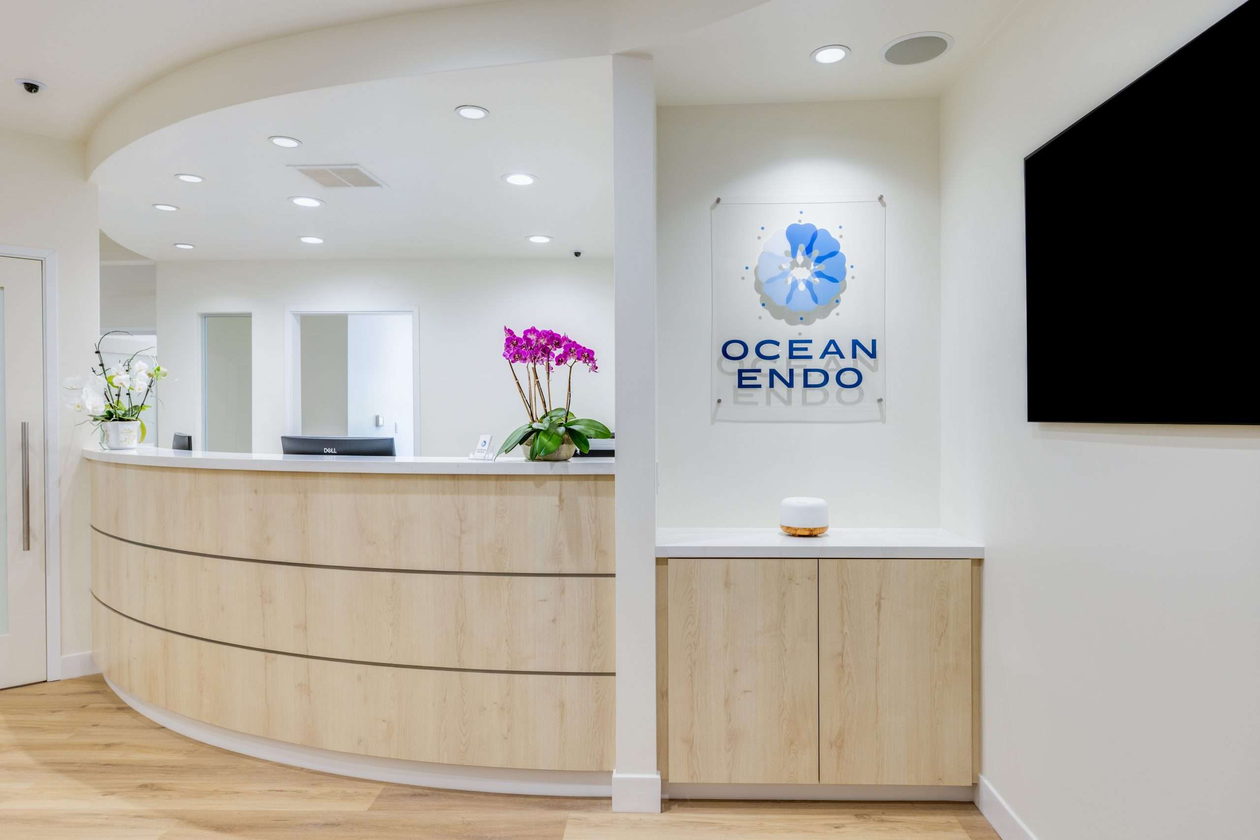 Front desk and Ocean Endo signage in the reception area of Ocean Endodontics in San Francisco