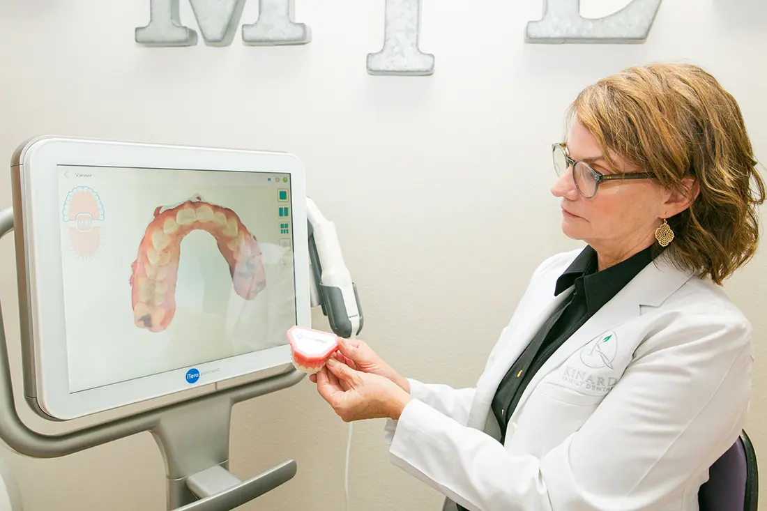 Dentist reviewing digital dental scan on iTero screen at Kinard Family Dental
