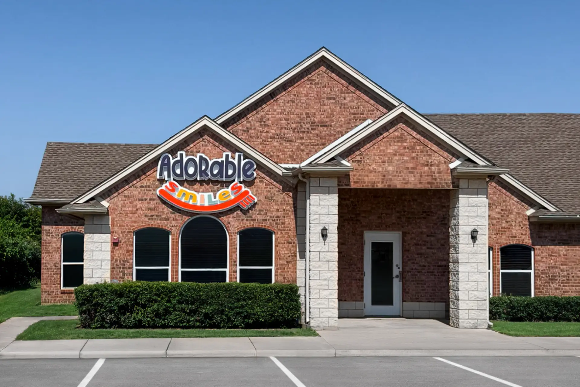 Exterior of Adorable Smiles Pediatric Dentistry building with signage in Corinth, TX