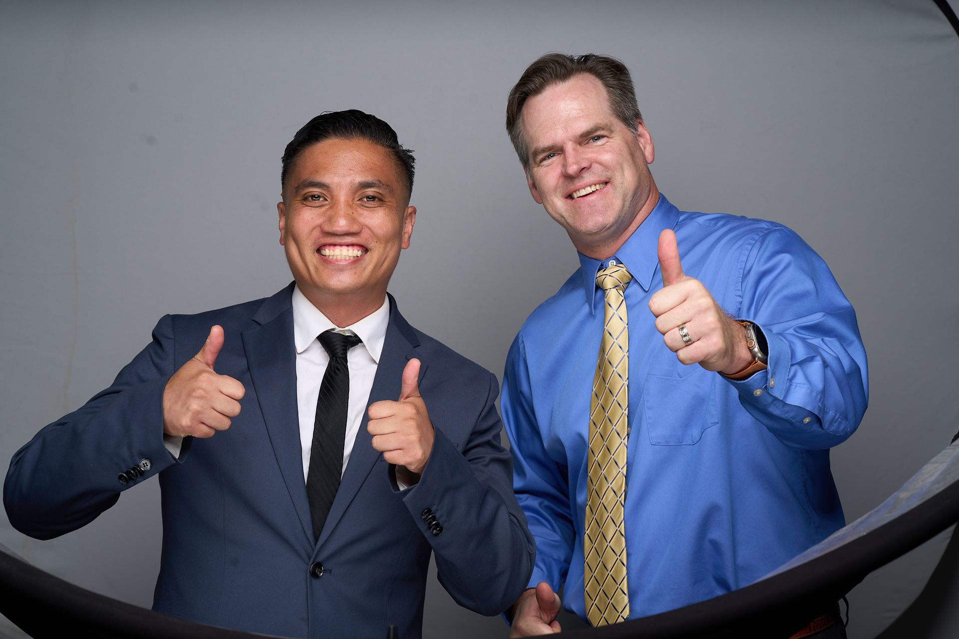 Dentists at Carson & Acasio Dentistry in Oxnard, CA giving thumbs up in a friendly portrait