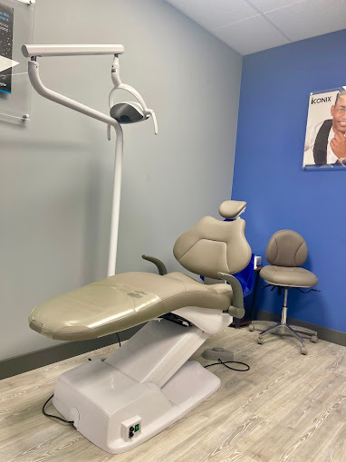 Treatment room with dental chair and light at Orthodontic Experts