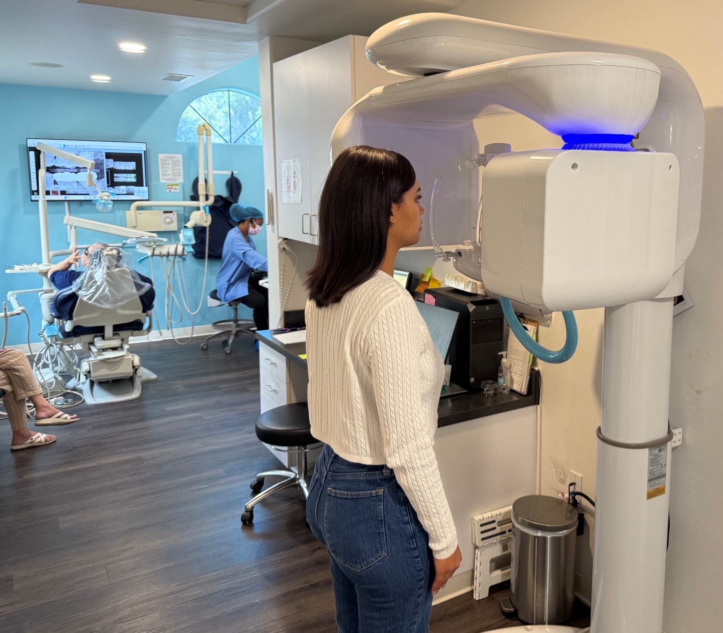 Patient positioned for a panoramic X-ray scan with treatment area visible in background at Dreamtime Dentistry