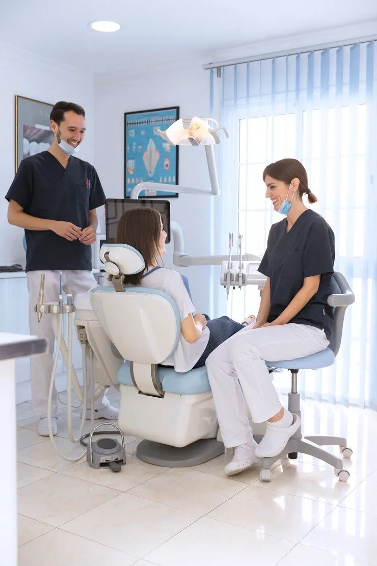 Dental team member consults with a patient in a treatment room at Amani Pediatric Dentistry in Cedar Park, TX