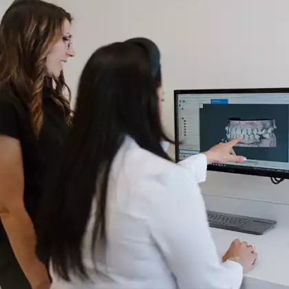 Staff reviewing digital dental scan on monitor at Smylique Dentistry