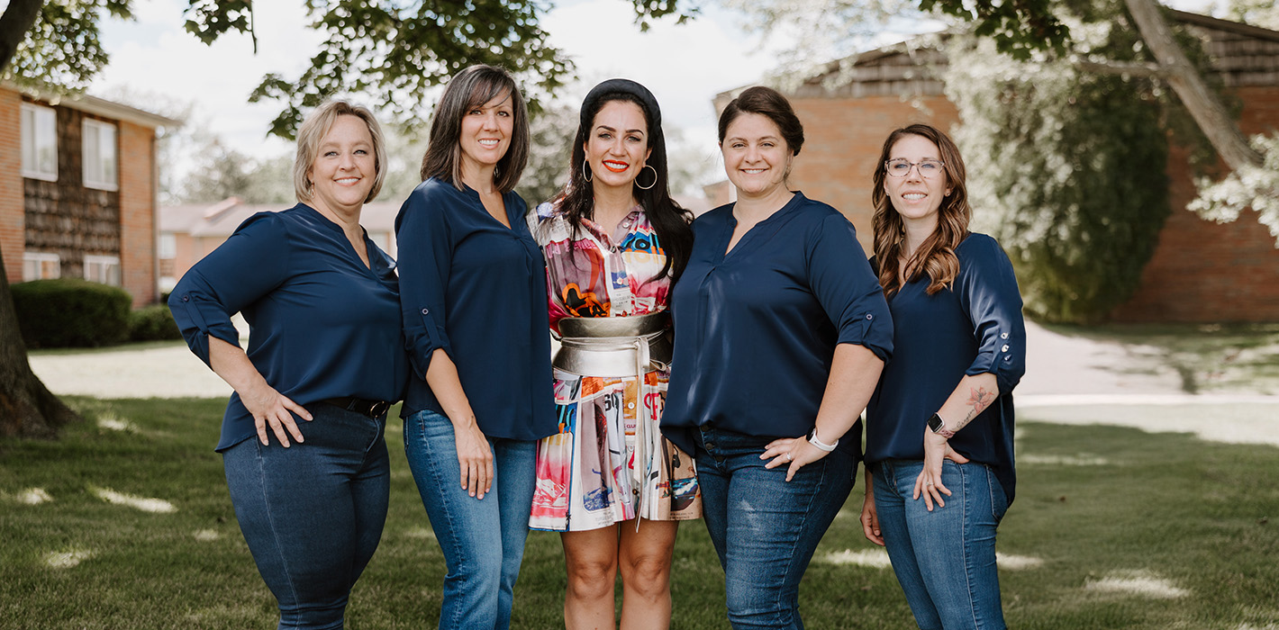 Team members posing outdoors at Smylique Dentistry in Rochester, NY