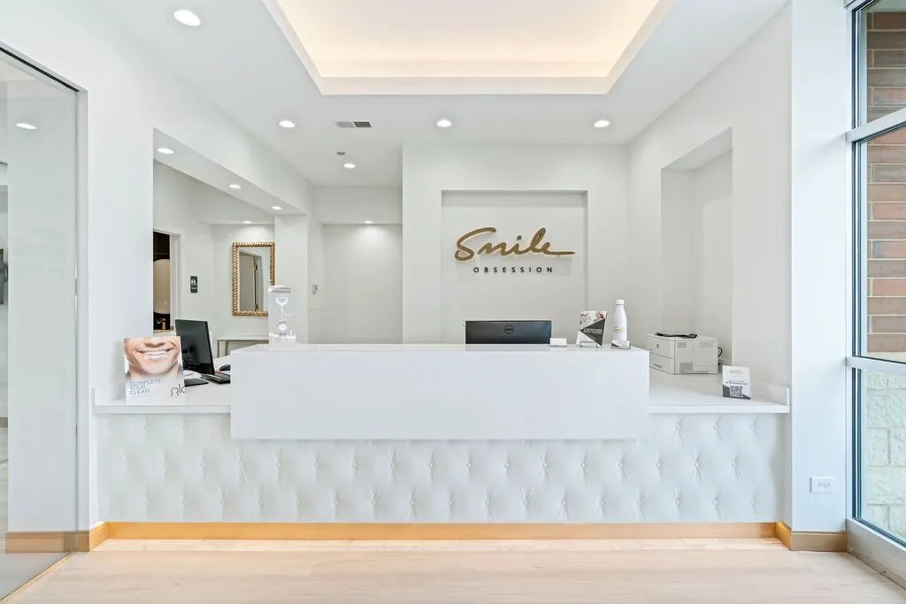 Reception desk with Smile Obsession signage at Smile Obsession - Naperville South