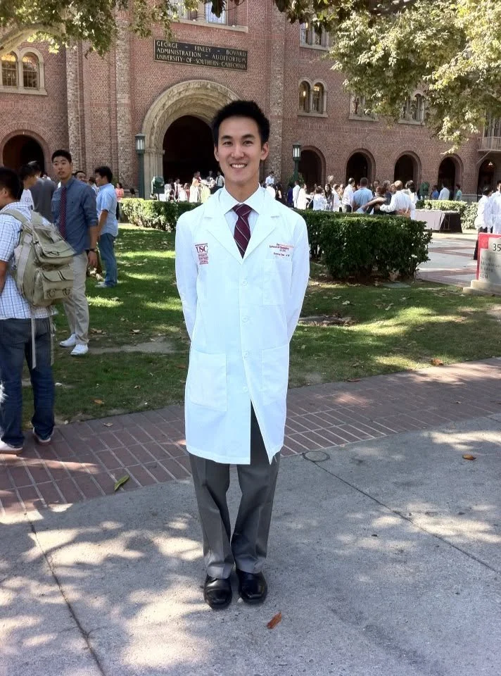 Dentist in white coat standing on USC campus at white coat ceremony, Jimmy Lau DDS