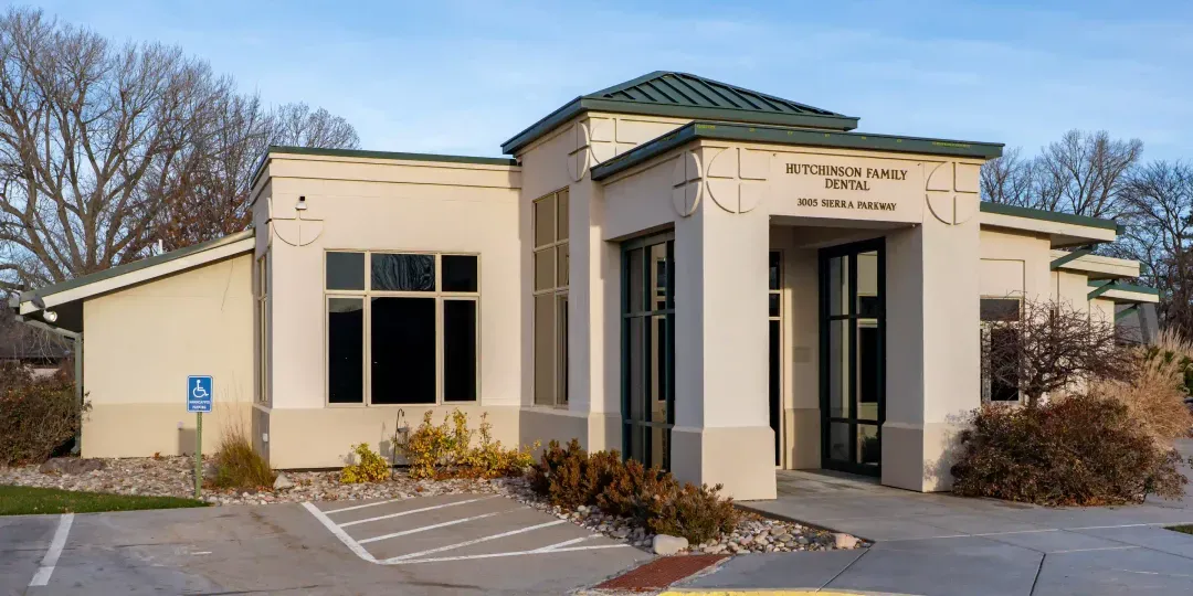 Hutchinson Family Dental building exterior with entrance and parking area