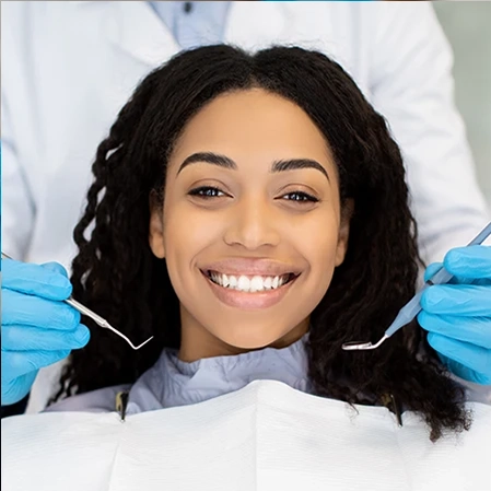 Smiling patient in dental chair during a checkup at Bella Family Dental