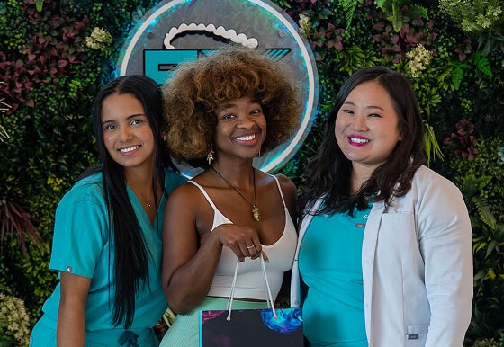 SMILE-FX staff and patient group photo at branded event backdrop