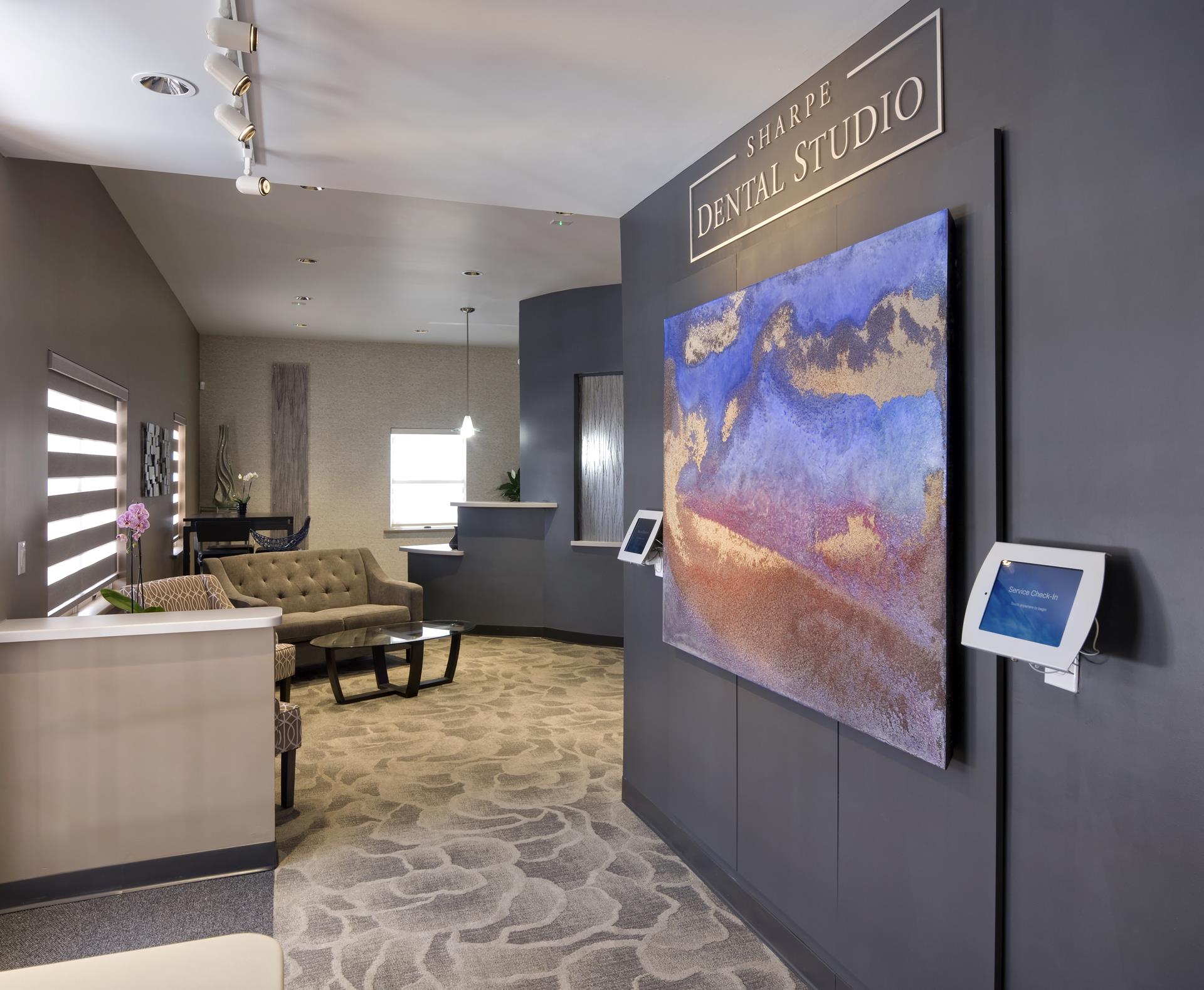 Reception and waiting area with artwork at Sharpe Dental Studio in Santa Fe