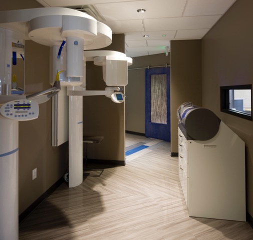 Panoramic X-ray imaging equipment in a treatment hallway at Sharpe Dental Studio