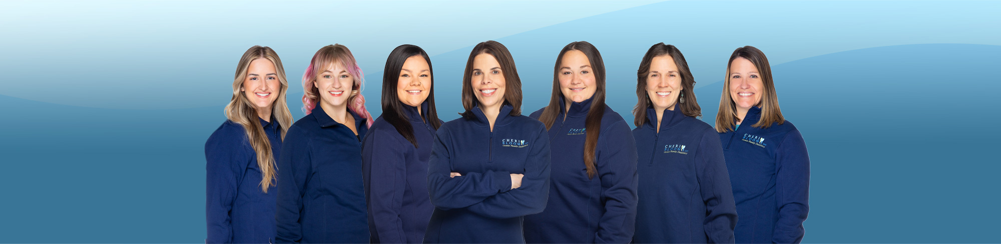 Group photo of the dental team at Cherilee C Bloom DDS wearing matching branded jackets