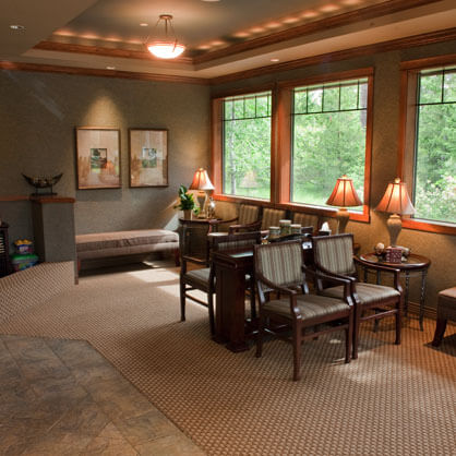 Waiting area with seating, lamps, and large windows at Cherilee C Bloom DDS