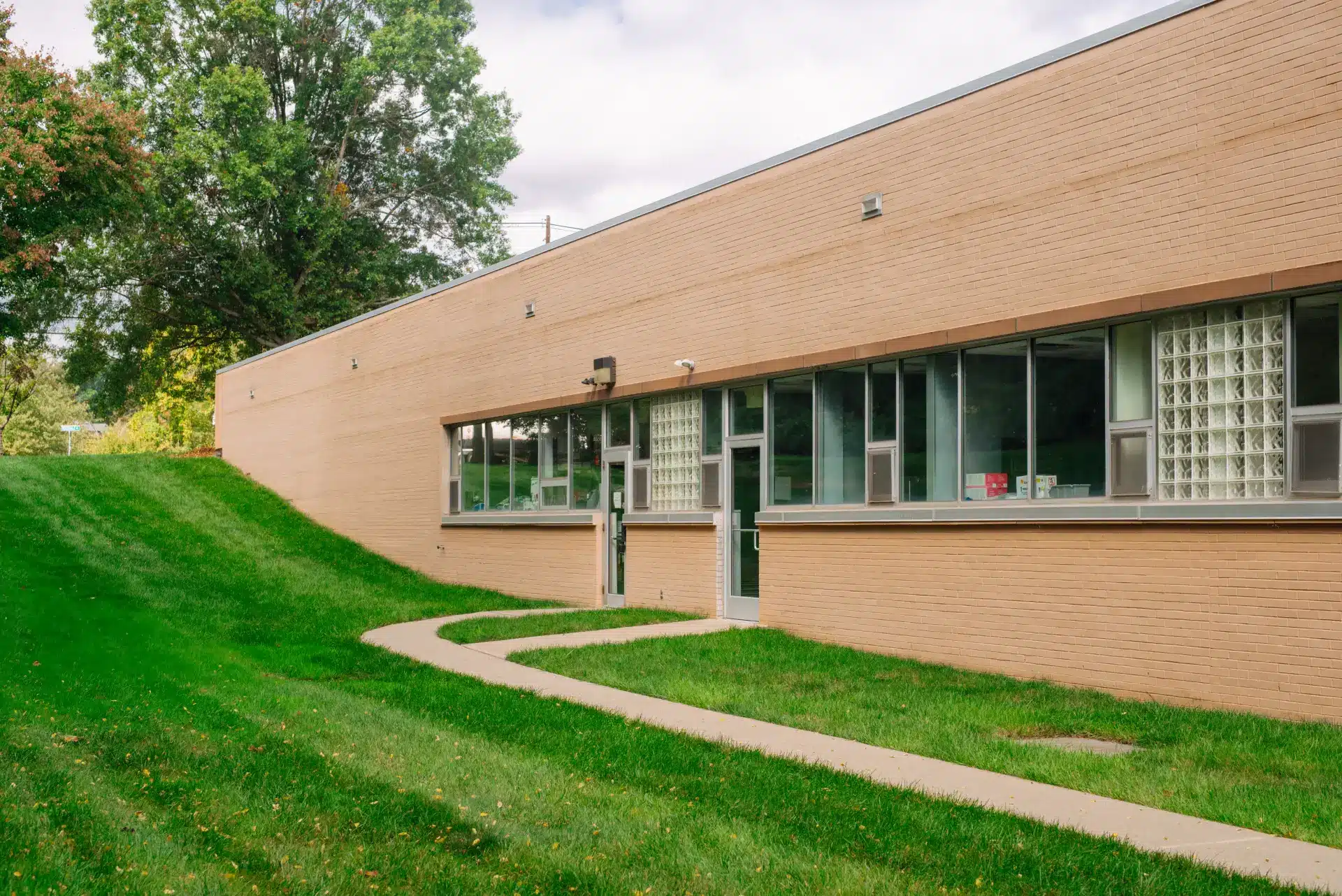Exterior view of The Advanced Dental Center building with walkway and landscaping