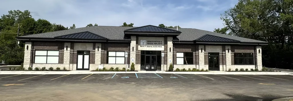 Street-level exterior view of the dental practice building with signage in Livonia, MI